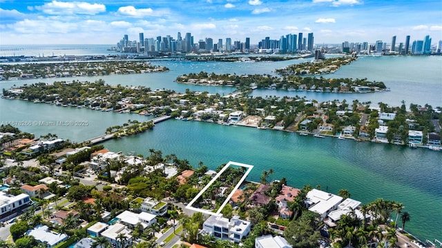 birds eye view of property featuring a water view and a view of city