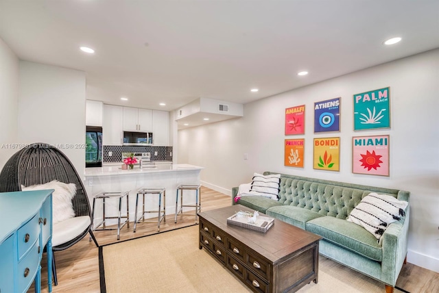 living room with light hardwood / wood-style floors