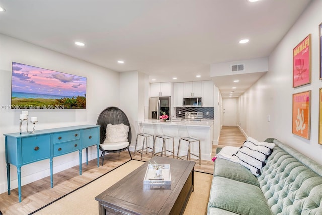 living room with light hardwood / wood-style floors