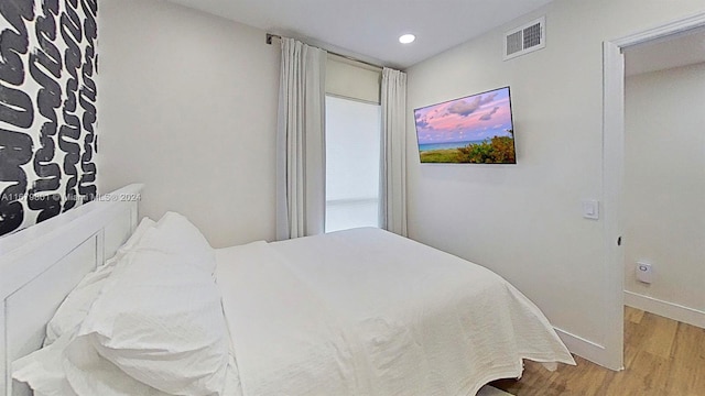 bedroom with wood-type flooring