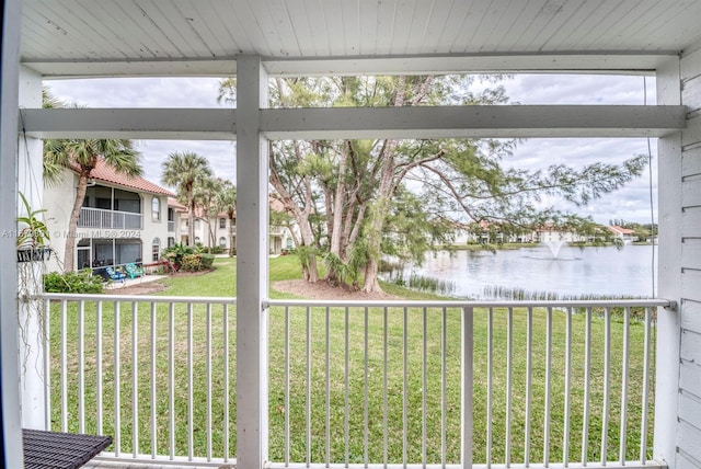 unfurnished sunroom featuring a water view and a fireplace