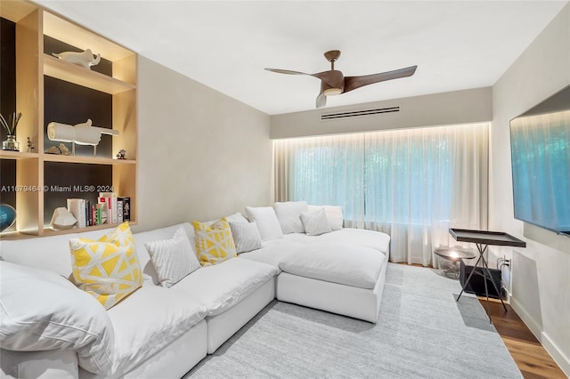 living room with hardwood / wood-style floors and ceiling fan