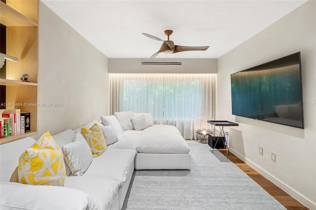 living room with wood-type flooring and ceiling fan