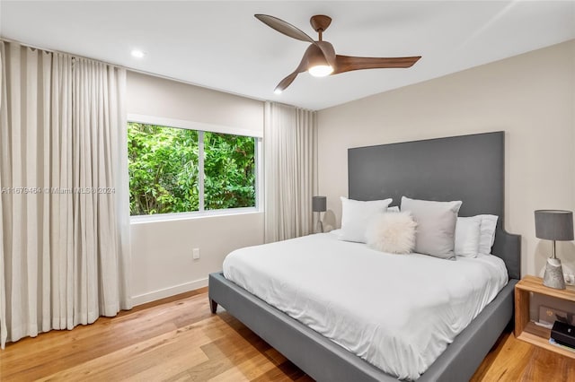 bedroom with ceiling fan and light hardwood / wood-style flooring