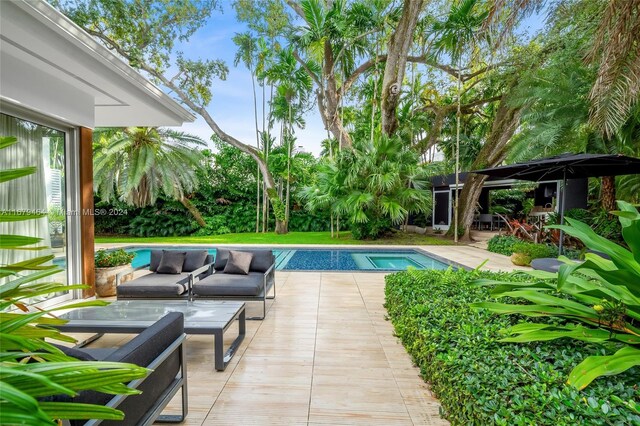 view of pool with outdoor lounge area and a patio