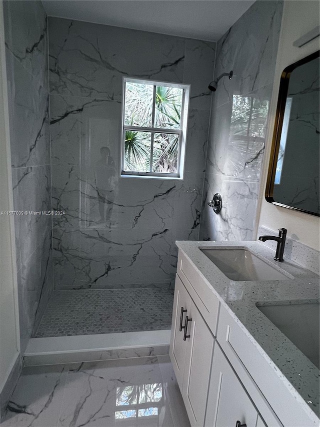 bathroom featuring vanity and tiled shower