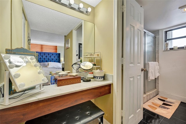 bathroom featuring an enclosed shower, tile patterned flooring, and a textured ceiling