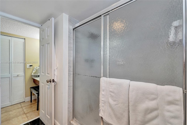 bathroom featuring a shower with door and tile patterned flooring