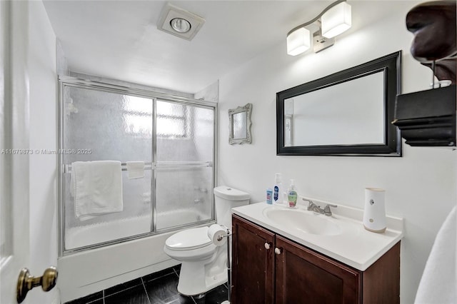 full bathroom with vanity, combined bath / shower with glass door, toilet, and tile patterned flooring