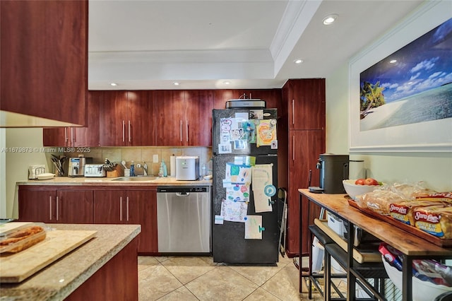 kitchen featuring sink, dishwasher, black fridge, crown molding, and decorative backsplash