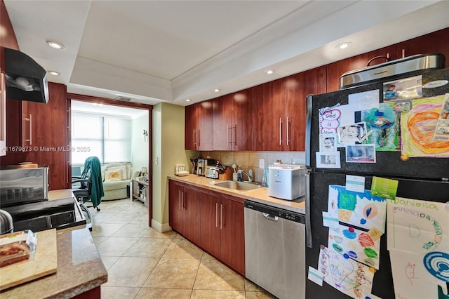 kitchen with sink, tasteful backsplash, dishwasher, light tile patterned flooring, and black fridge