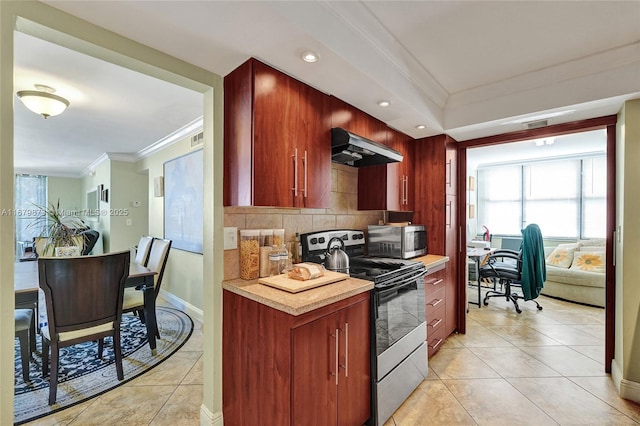 kitchen with crown molding, light tile patterned floors, stainless steel appliances, and backsplash