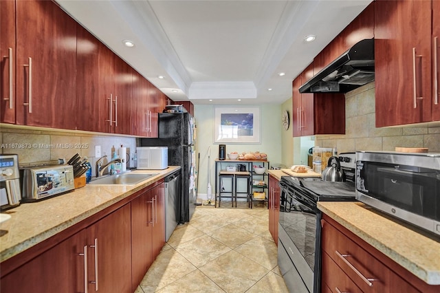 kitchen featuring appliances with stainless steel finishes, sink, tasteful backsplash, and a raised ceiling