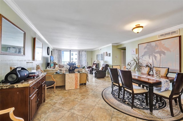 tiled dining room featuring crown molding