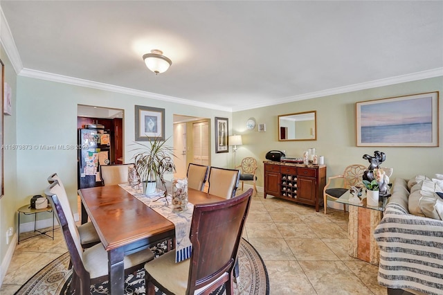 tiled dining area featuring crown molding