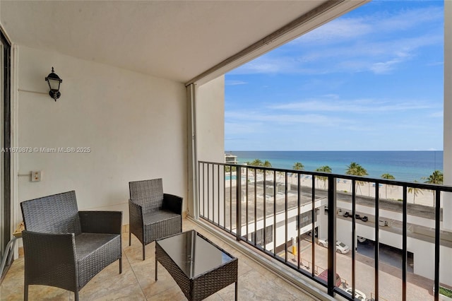 balcony with a water view and a beach view