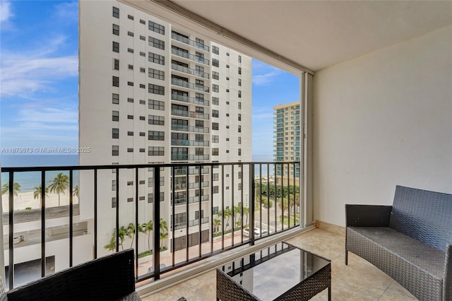 balcony with a water view and a beach view