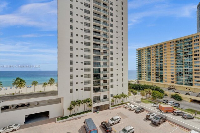 view of property featuring a beach view and a water view