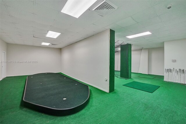 interior space with carpet floors and a drop ceiling