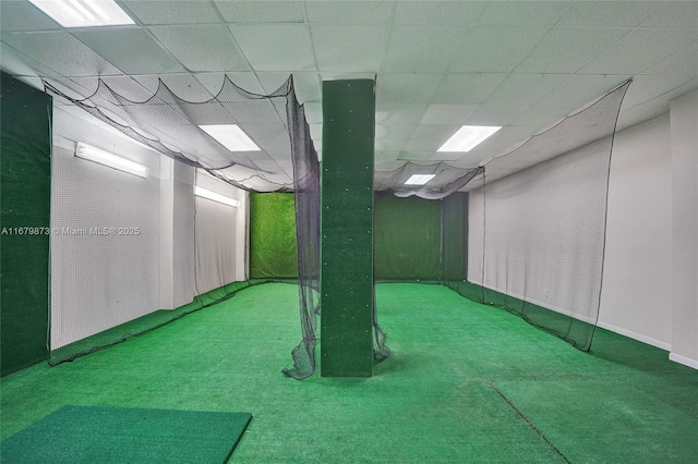 basement featuring a drop ceiling and carpet