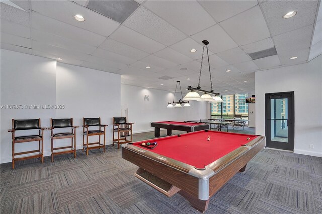 playroom featuring a paneled ceiling, pool table, and dark carpet