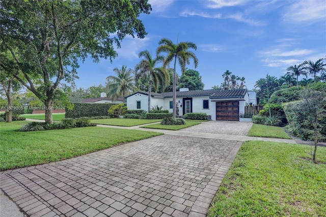 single story home with a front lawn and a garage