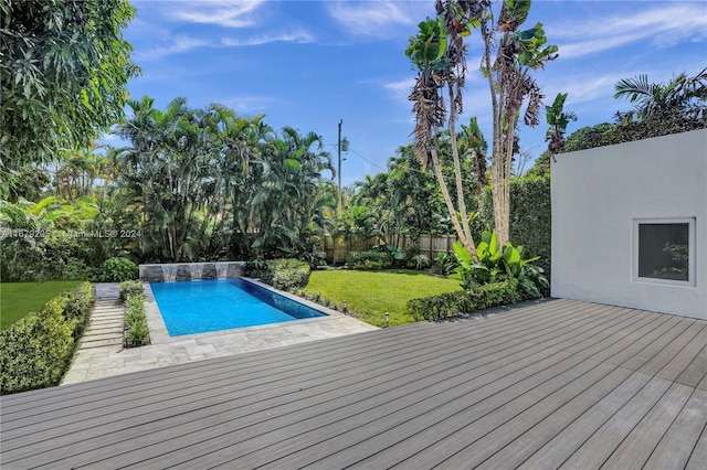 view of pool featuring a deck and a lawn