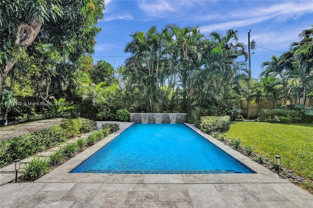 view of pool featuring a yard