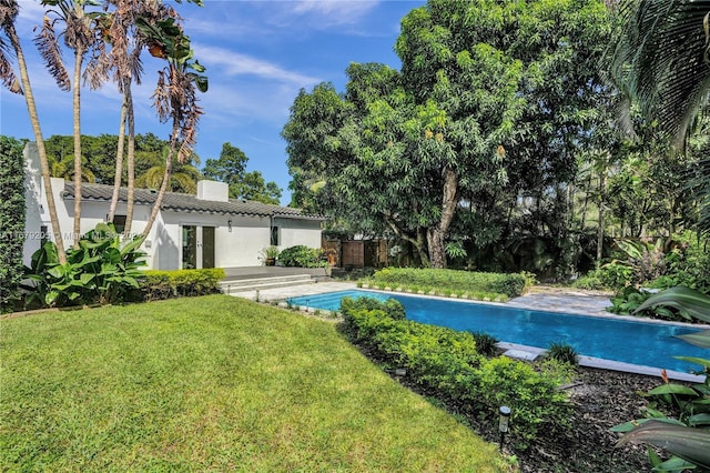 view of pool with a yard and a patio