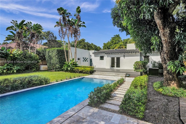 view of swimming pool with a patio and central AC unit