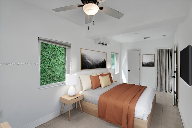 tiled bedroom with a wall mounted air conditioner and ceiling fan