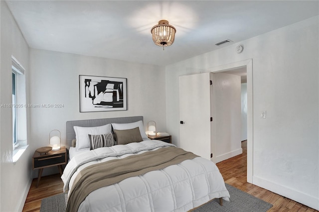 bedroom with hardwood / wood-style floors