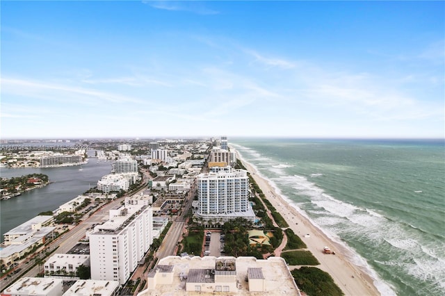 drone / aerial view featuring a water view and a view of the beach