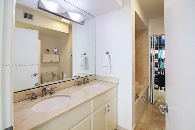 bathroom with a bathtub, toilet, tile patterned floors, and vanity