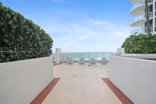 view of patio / terrace featuring a balcony and a water view