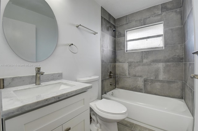 full bathroom featuring vanity, toilet, tile patterned floors, and tiled shower / bath combo