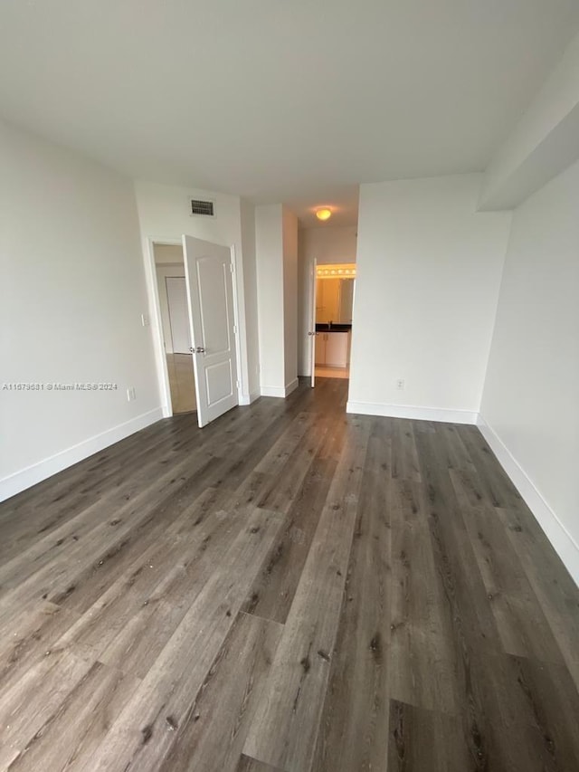 unfurnished living room featuring dark wood-type flooring