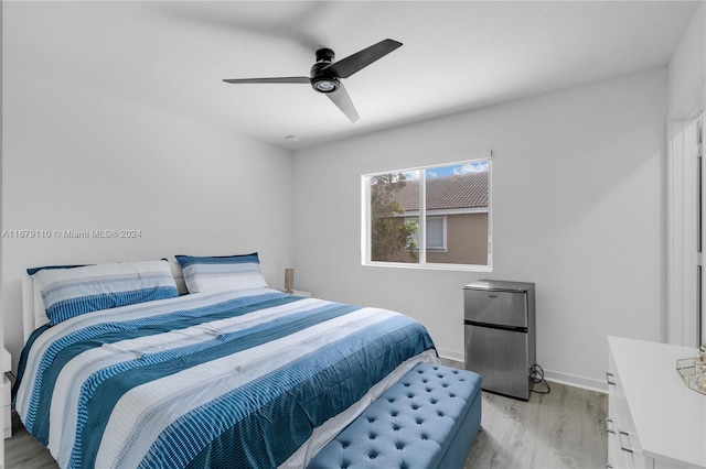 bedroom with light hardwood / wood-style floors and ceiling fan