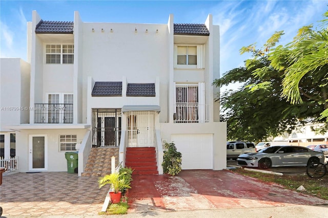 view of front of property with a balcony and a garage