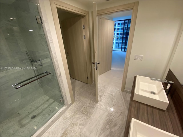 1000 Brickell Plz Unit 2907, Miami, FL 33131 - full bath featuring a marble finish shower, vanity, and marble look tiles
