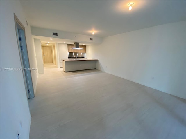 unfurnished living room with sink