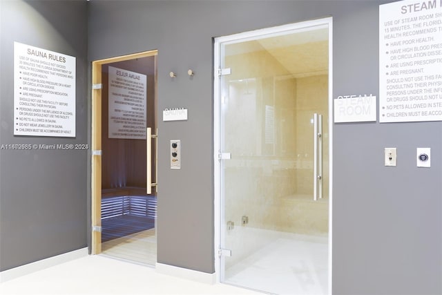 bathroom with wood-type flooring and an enclosed shower