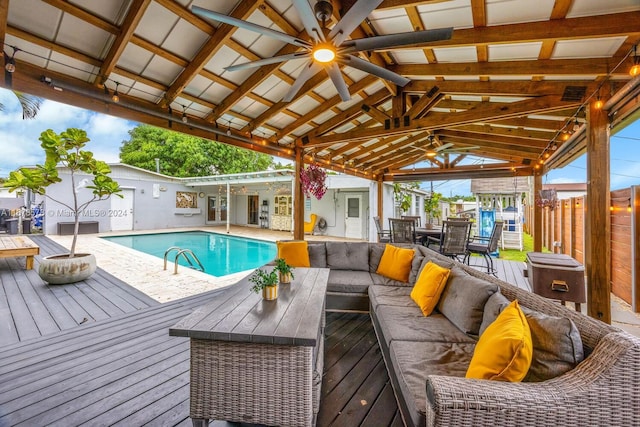 view of pool with a wooden deck, an outdoor hangout area, and ceiling fan