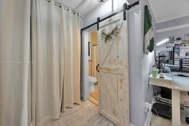 bathroom featuring hardwood / wood-style flooring and toilet