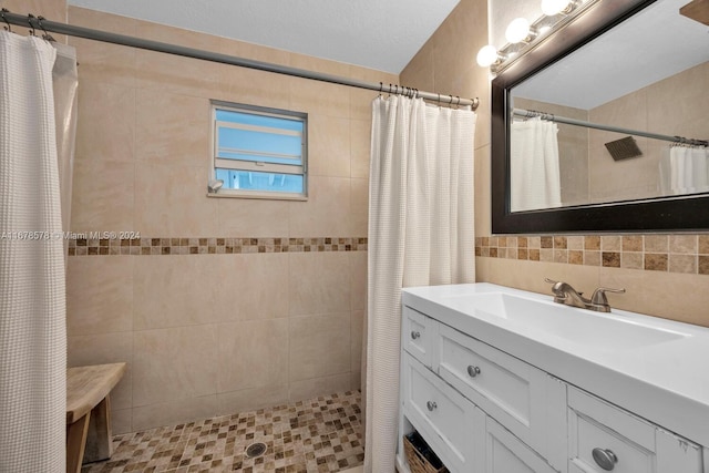 bathroom featuring vanity, backsplash, tile walls, and a shower with curtain