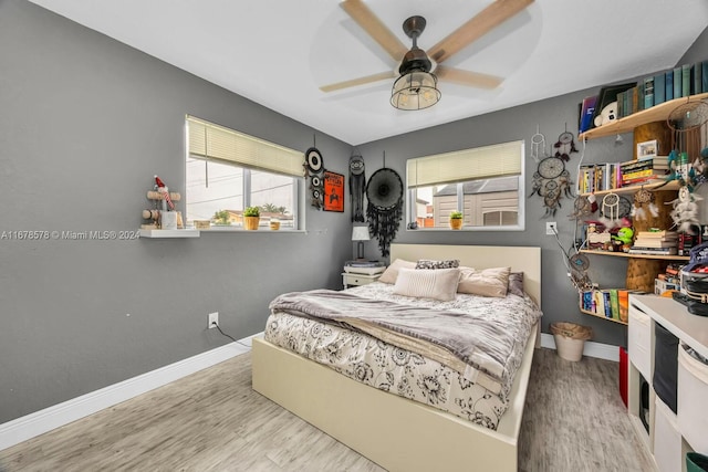 bedroom featuring light hardwood / wood-style flooring and ceiling fan