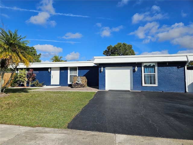 ranch-style home with a garage and a front lawn