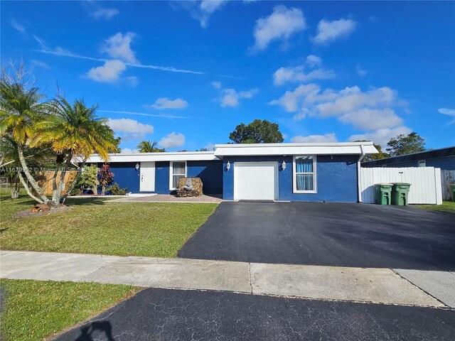 single story home with a front yard and a garage