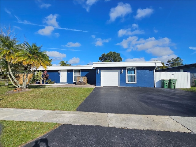 single story home featuring a garage and a front yard