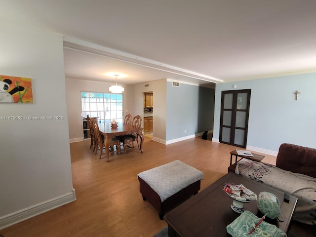 living room featuring wood-type flooring and ornamental molding